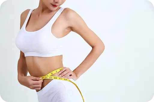 Person measuring waist progress during a weight loss journey